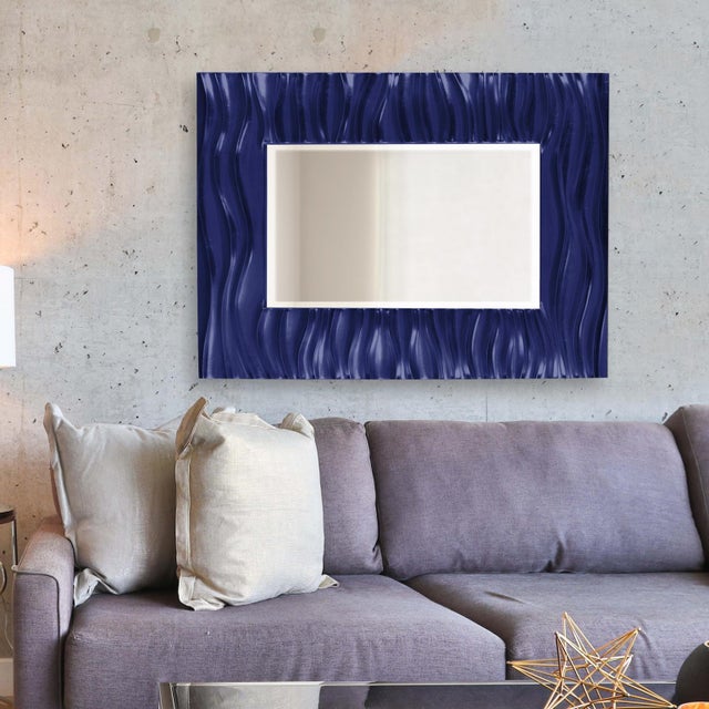 Our Zenith Mirror features a rectangular frame that is characterized by a deep textured wave design. The waves give an...