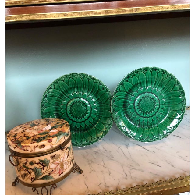 A pair of Wedgwood 19th century green glazed majolica sunflower plates from England.