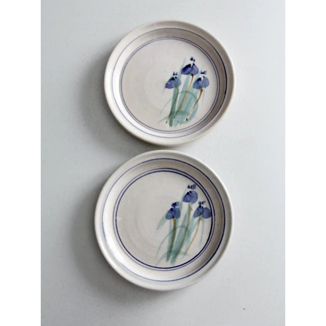 This pair of vintage studio pottery plates is signed by the artist and beautifully hand-crafted. Each plate features a...