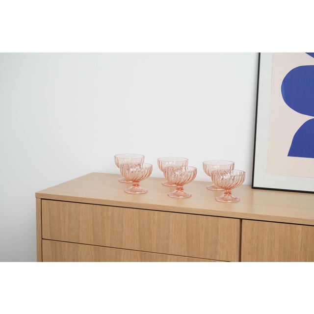 The set of pink dessert bowls was made in the 1970s in Italy. Six glass dessert bowls in a delicate pink colour. The...