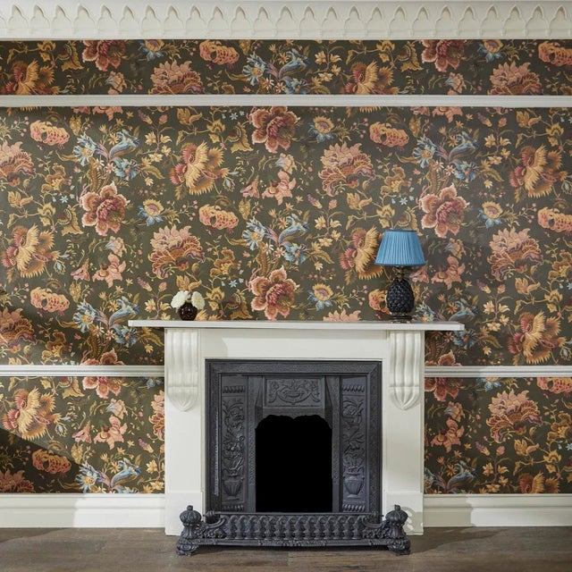 The moss-green 'Majorelle' wallpaper features a floral print inspired by Jacobean designs and has been created in...