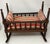 This salesman sample or doll's cradle measures 15.25" long x 11.75" wide at rocker x 13.5" to top of spindle. It has the...