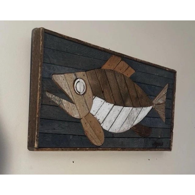 This lathe-art wall panel is of a fish. It is wood plank construction with applied and shaped wood elements, blue, tan,...