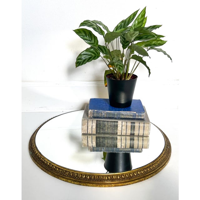 Large and eye-catching vintage gilt metal plateau featuring a newly added mirrored surface. The frame, originally part of...