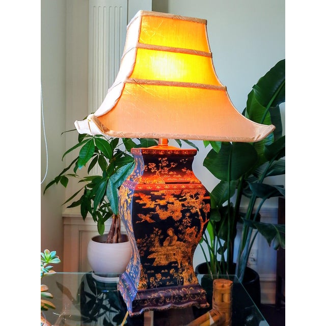 Elegant chinoiserie table lamp in the manner of Frederick Cooper, featuring a richly decorated lacquered body with...