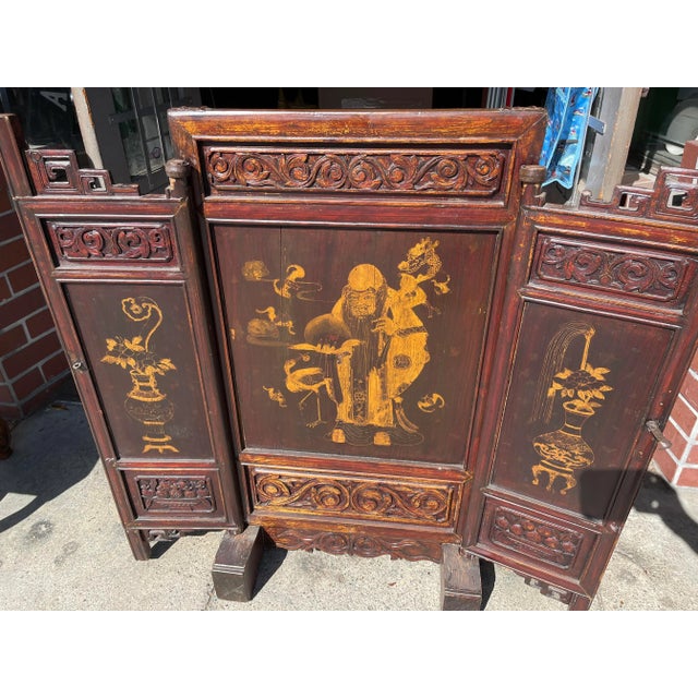 Antique Asian Screen with gilt decoration, the front decorated with vases which open to reveal a gilt figure. The doors...
