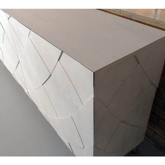 Sedici is a solid wood sideboard with an extremely systematical shape. All visible parts are assembled with 45-degree cuts...