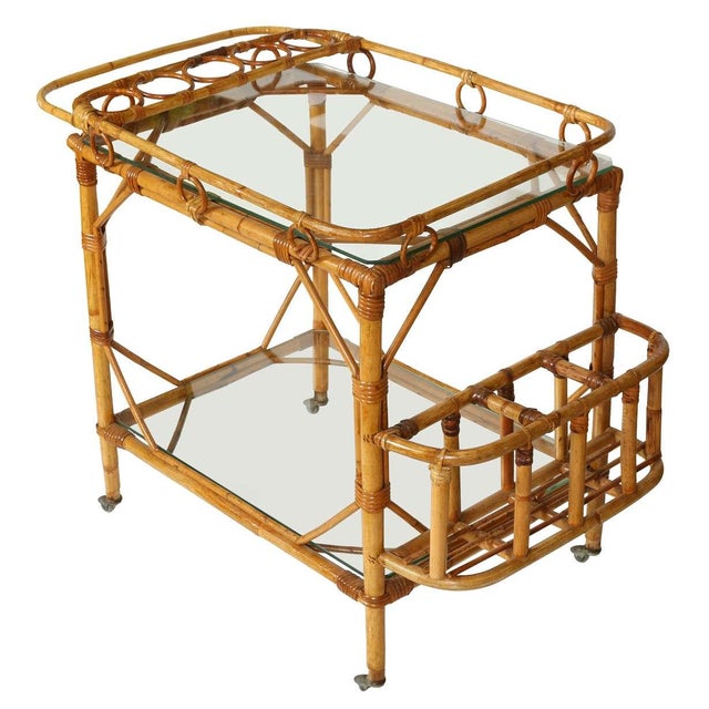 This beautifully crafted vintage bamboo and glass bar cart brings effortless coastal charm and timeless style to any...