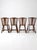 Set of four vintage mid-century wood dining chairs with a sculptural folk-inspired design, distinctive shaped legs, and a...