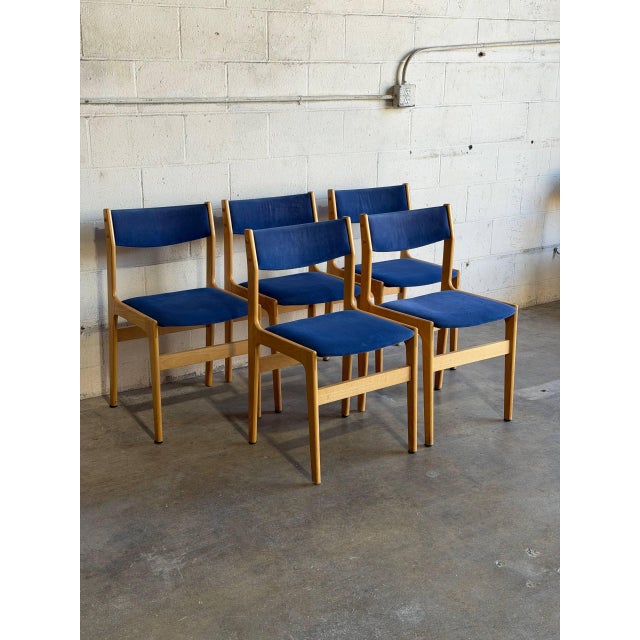 Beautiful set of 5 vintage Danish modern dining chairs crafted in Denmark, featuring sculptural solid wood frames and...