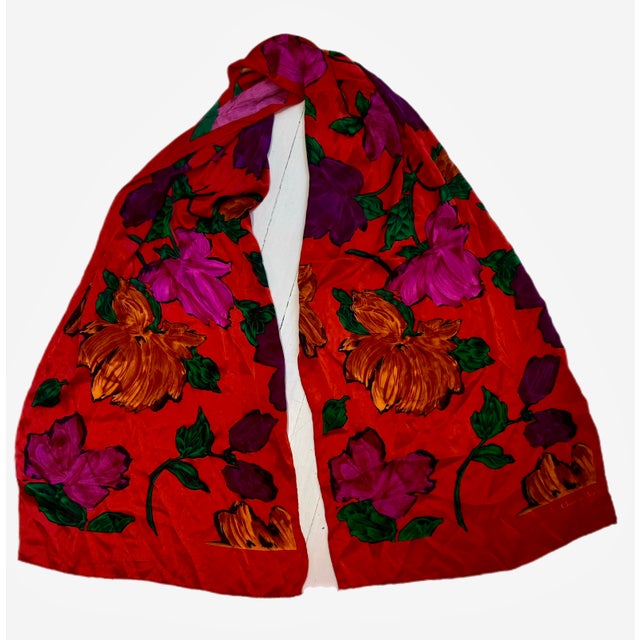 Christian Dior red silk scarf with dynamic graphic floral pattern. Hand rolled hems. Signed. Circa late 20th century.