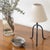 Petite iron tripod lamp with slender legs and tapered feet. New wiring and new linen shade. Sold individually and newly...