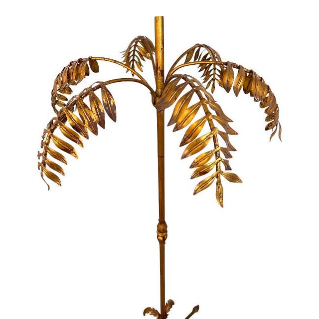 Stunning vintage gilt-iron trefoil floor lamp featuring beautifully sculpted botanical leaves and cascading fronds, giving...