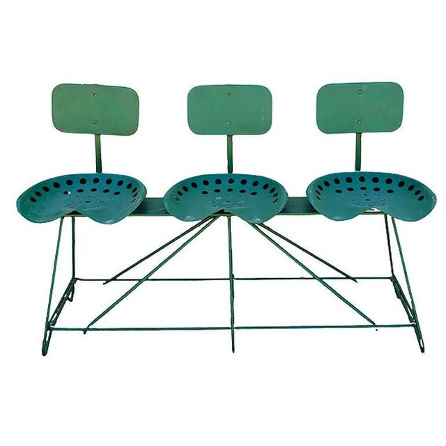 Folk art industrial style three-seat bench featuring 3 steel tractor seats with steel backrests mounted on a welded...