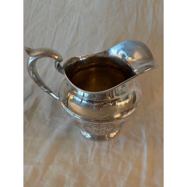 Early 20th century American Spaulding & Co. sterling silver pitcher featuring classic proportions and a refined,...