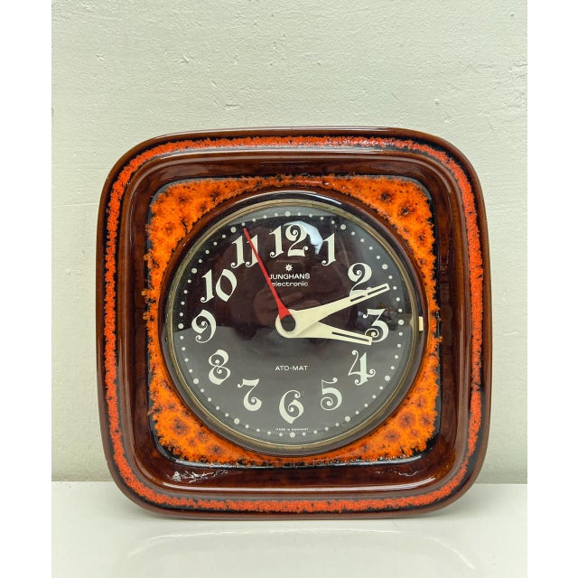 Beautiful Junghans Wall Clock made of ceramic I the colours orange and brown. with beautifully designed numerals and...