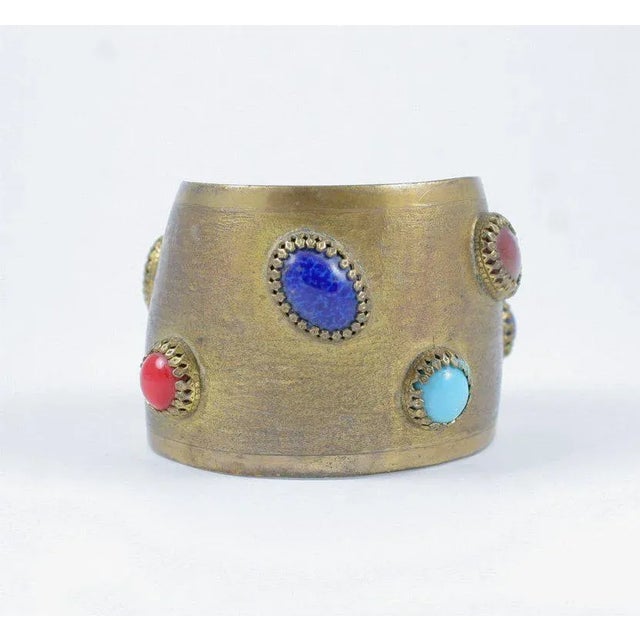 This is part of Chairish’s Costume Jewelry assortment. Antique brass finished cuff adorned with faux semi precious...