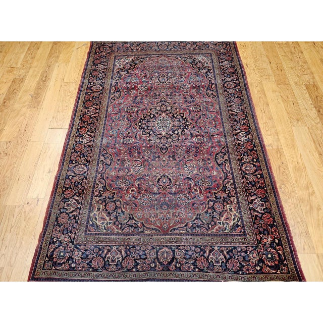 "A striking early 20th century antique Persian Kashan area rug of great technical refinement and classical beauty, hand-...
