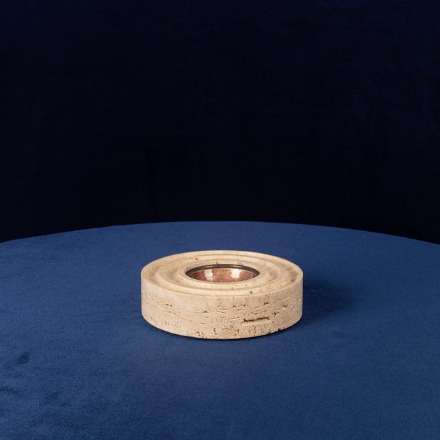 Overview A sculptural round ashtray made in Italy in 1970, featuring a solid travertine body with concentric carved rings...