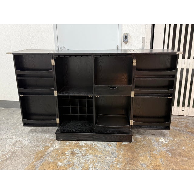 Design Plus Gallery presents a Steamer Bar by Crate & Barrel. In a black ash veneer with pronounced wood grain variation,...