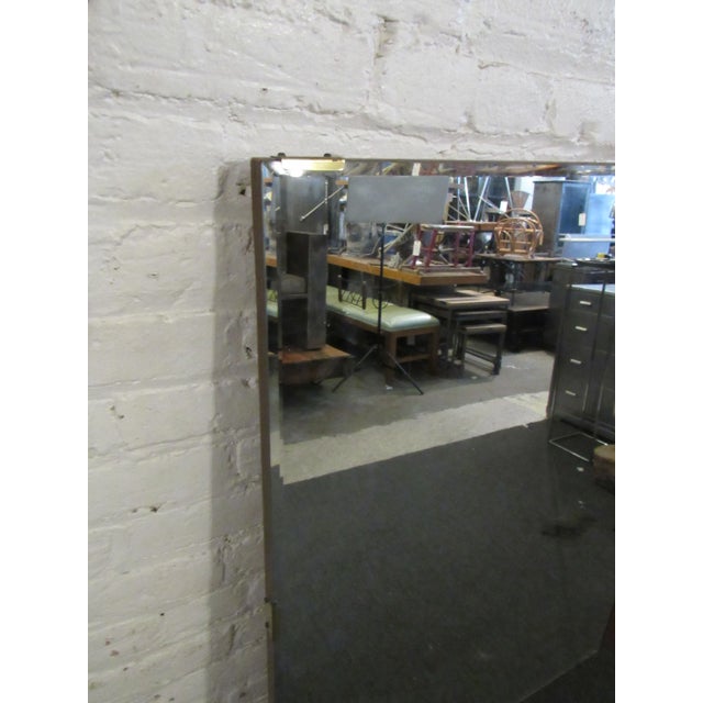 With two mirror panels and elegant wooden accents, this large mirror brings unique Mid-Century Modern taste to an interior...