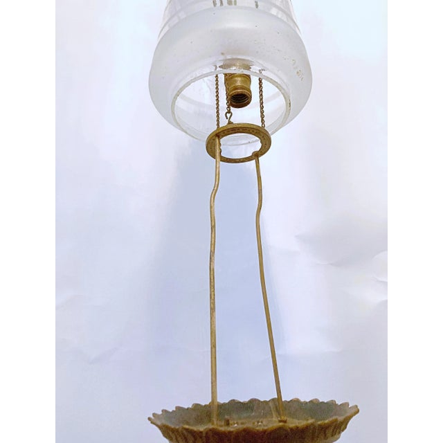 This Lantern has a rise and fall chain suspension shown in polished brass with an decorative frosted glass shade. It was...