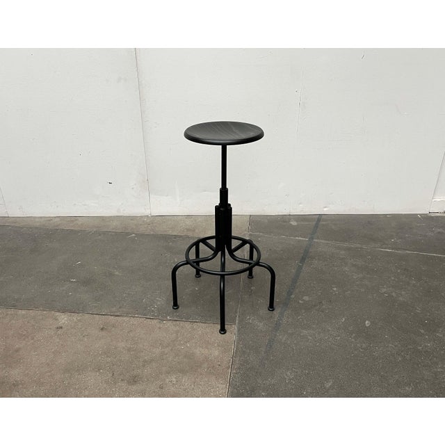 Height-adjustable swivel stool from the renowned manufacturer lambert. a functional design inspired by classic industrial...