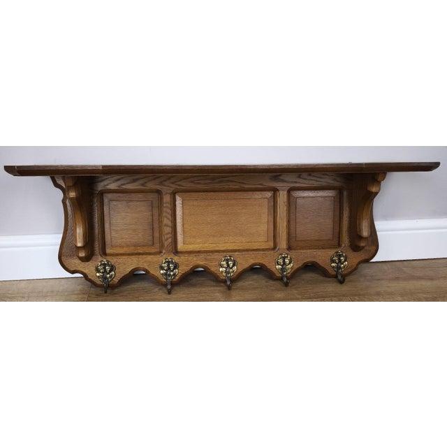 A beautifully crafted Vintage French coat hanger, combining elegant form with practical design, featuring a rich oak...