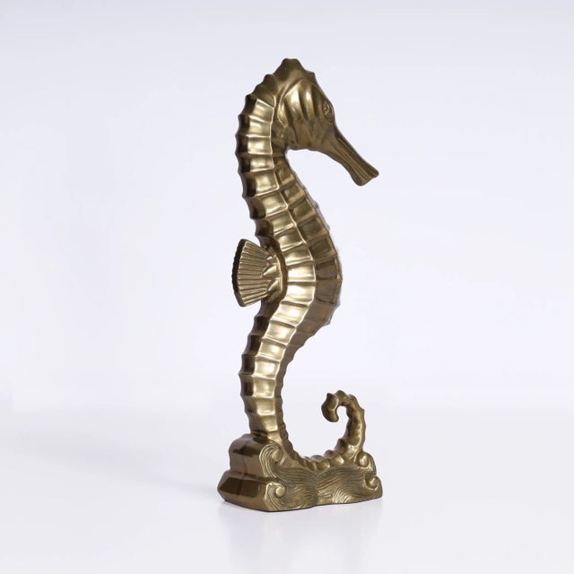 Charming Mid Century stylized seahorse sculpture crafted in bronze in an art deco form with a custom acid washed finish.