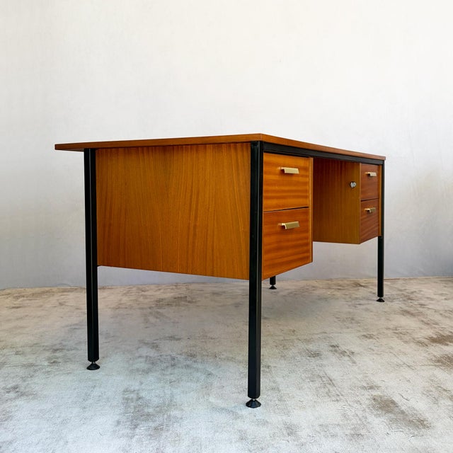 Twin-pedestal desk with two banks of two drawers, each fitted with satin brass handles. Black steel frame with tapered...