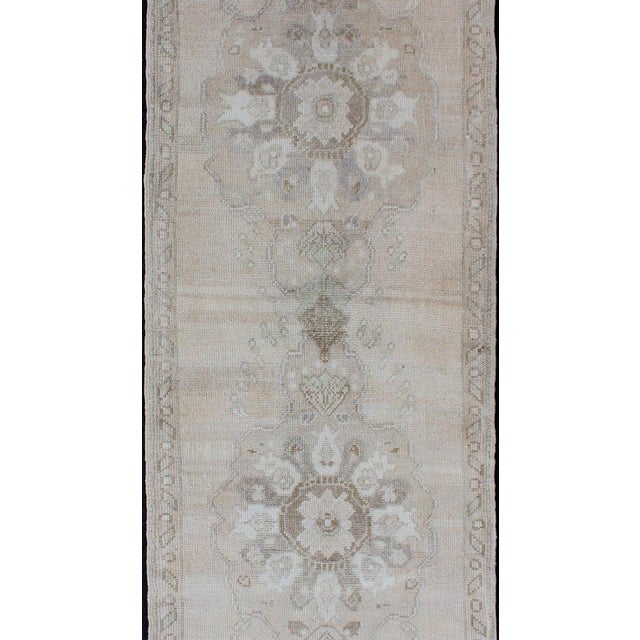 Measures: 2'5 x 7'7 Vintage Turkish Oushak Runner in Sand, Soft Taupe, and Faded Ivory 2'5 x 7'7. Keivan Woven Arts / Rug...