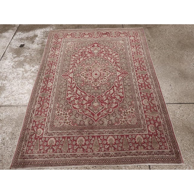 This Early 20th century Persian Tabriz rug, measuring 4' 0" x 5' 7", displays the refined artistry and balanced symmetry...