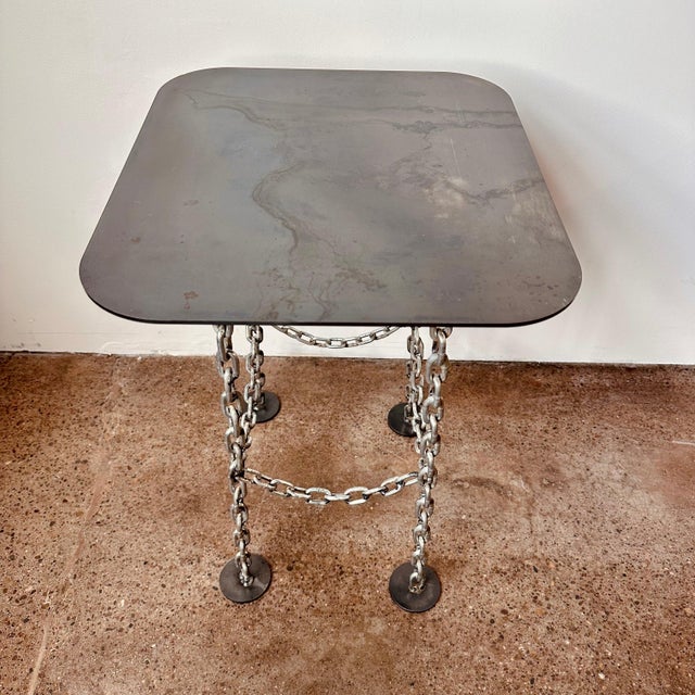 Industrial brutalist style welded chain link side table with steel top