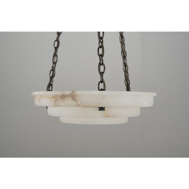 Art Deco style light made from hand cut alabaster from Tuscany. Shown with brass hardware and chain and a polished nickel...