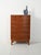 A 1940s–1950s mahogany chest of drawers with contoured brass handles, spacious drawers, and balanced proportions. An...