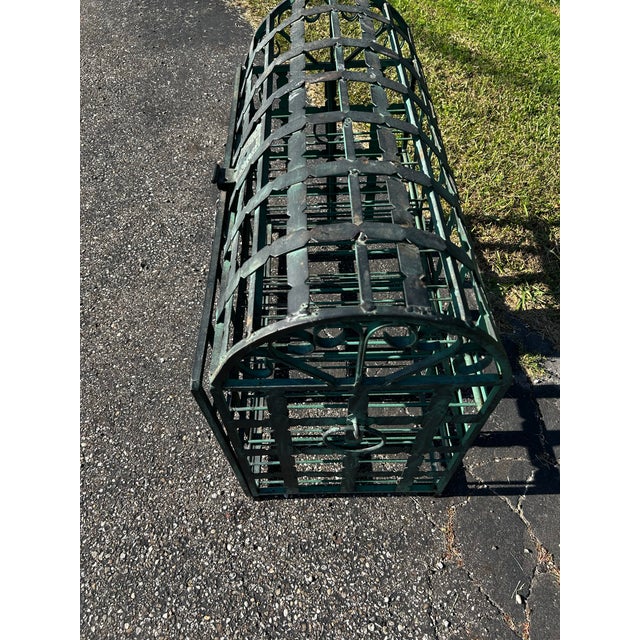 This is a French wrought-iron domed wine chest storage rack. It is designed to store wine bottles within an openwork grid...