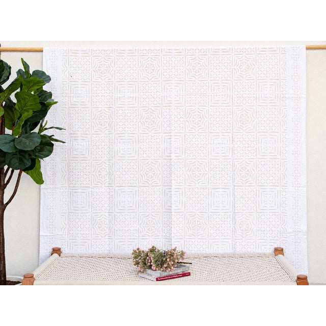 A lightweight cotton coverlet from Western India, beautifully adorned with intricate handcrafted appliqué cutwork. The...