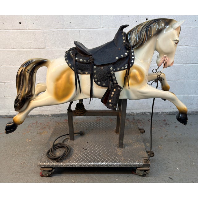 Mechanical pony/horse kiddie ride from the mid 20th century. Molded fiberglass body with painted details, a black tooled...