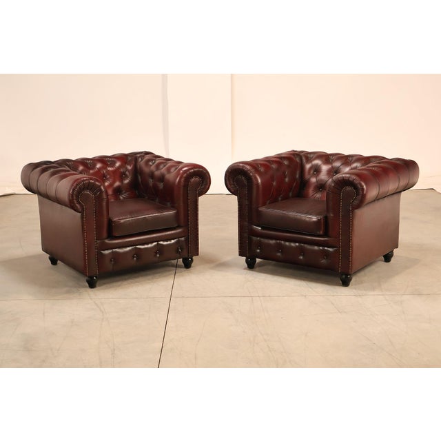 High Quality Pair of Tufted Red Leather Lounge Chairs with Brass Tack Trim, Mounted on Turned Feet