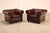 High Quality Pair of Tufted Red Leather Lounge Chairs with Brass Tack Trim, Mounted on Turned Feet