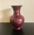 This vase is made of glass and it was hand painted. It also is painted on the inside a cooper color and has a bamboo motif...