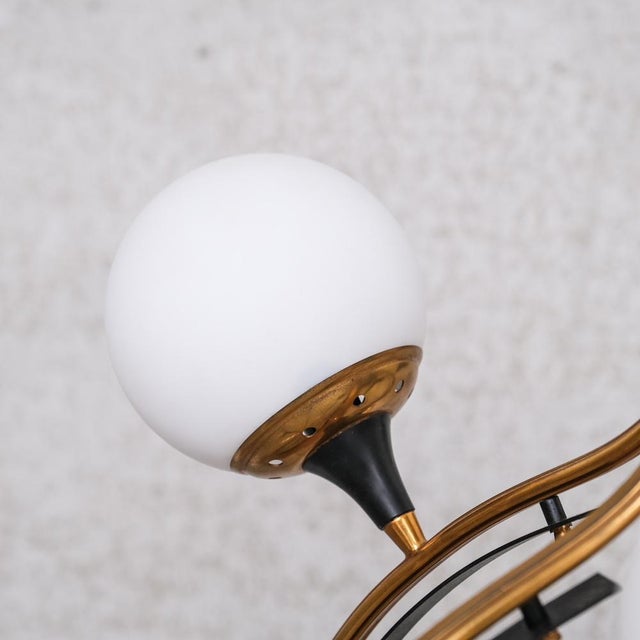 A large chandelier attributed to stilnovo. italy, 1950s. brass, lacquered metal and opaline glass spheres. since re-wired...