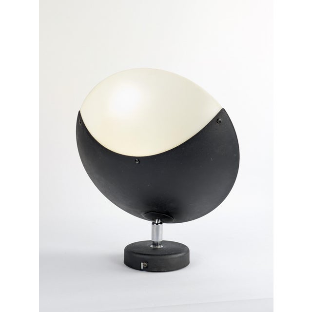 Dimensions: Ø30 x h 12 cm Weight: 0.9 kg Wall light made of painted iron and translucent plastic. The saucer pivots and...