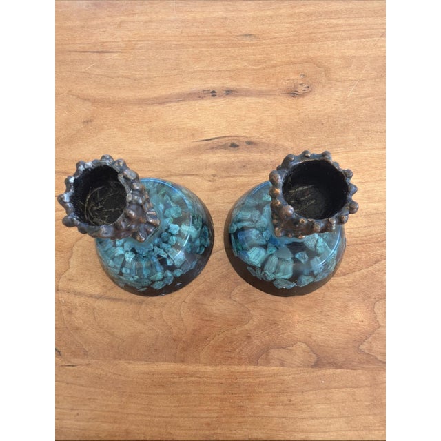 Vintage mid-century modern candlestick holders featuring clear cast resin bases embedded with green mineral stone chips,...