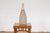 An artisan made bottle-shaped ceramic vase with light brown background and energetic cream dripping. This contemporary,...