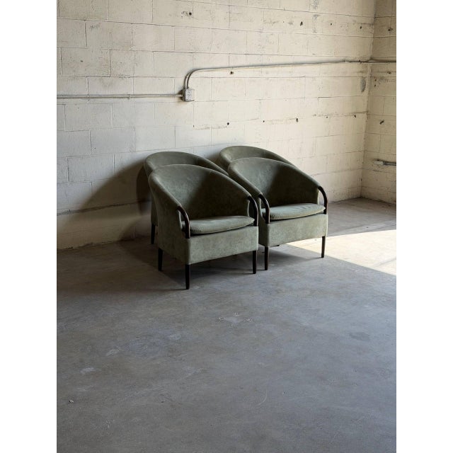 Beautiful set of 4 vintage Danish modern lounge chairs featuring sculptural curved silhouettes, elegant wooden arm...