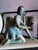 Art Deco figural marble mantel clock featuring a patinated bronze or spelter sculpture of a seated young girl, created by...
