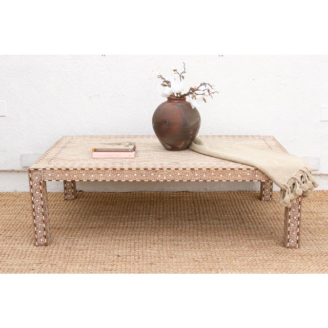 Spanning an impressive 60 inches in length, this fine inlaid coffee table is a masterpiece of precision and patience. It...