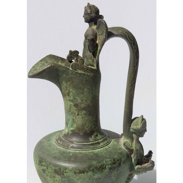 Bronze ewer with winged figure. Grand tour after the original ancient roman ewer. Made 19th century. Excellent quality.