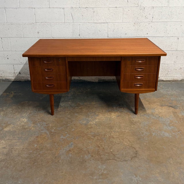 This Danish teak executive desk is an absolute beauty. Featuring 8 drawers and the original key that goes to them, as well...